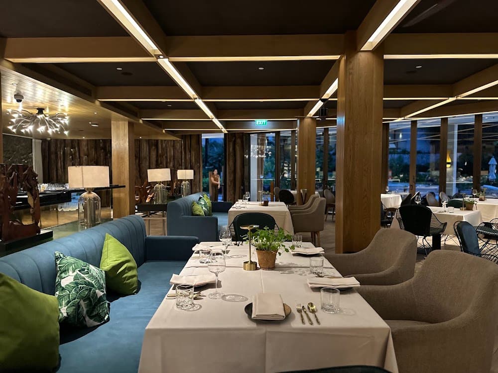 PRU dining room at Trisara resort with blue velvet banquettes and tropical cushions
