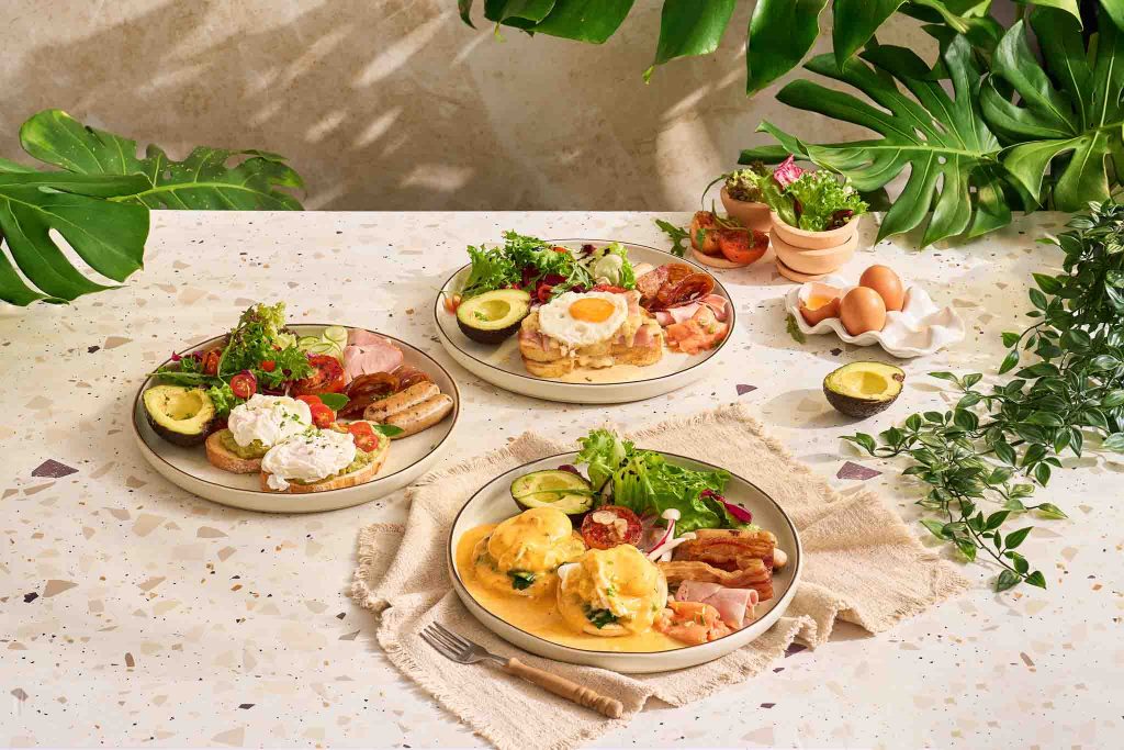 Assorted brunch plates with eggs, avocado, salad, and toast from Manow Brunch & Bistro in Kata Karon, Phuket.