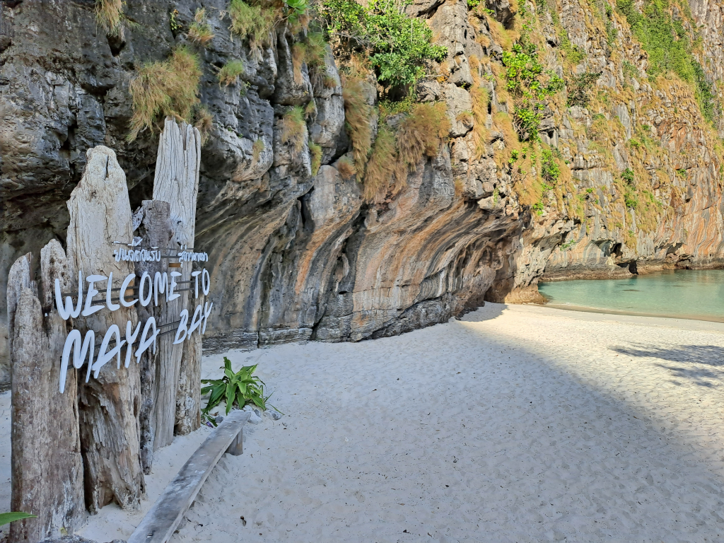 Maya Bay in Phi Phi Islands with white sand beach and dramatic limestone cliffs, a popular island hopping stop from Phuket.