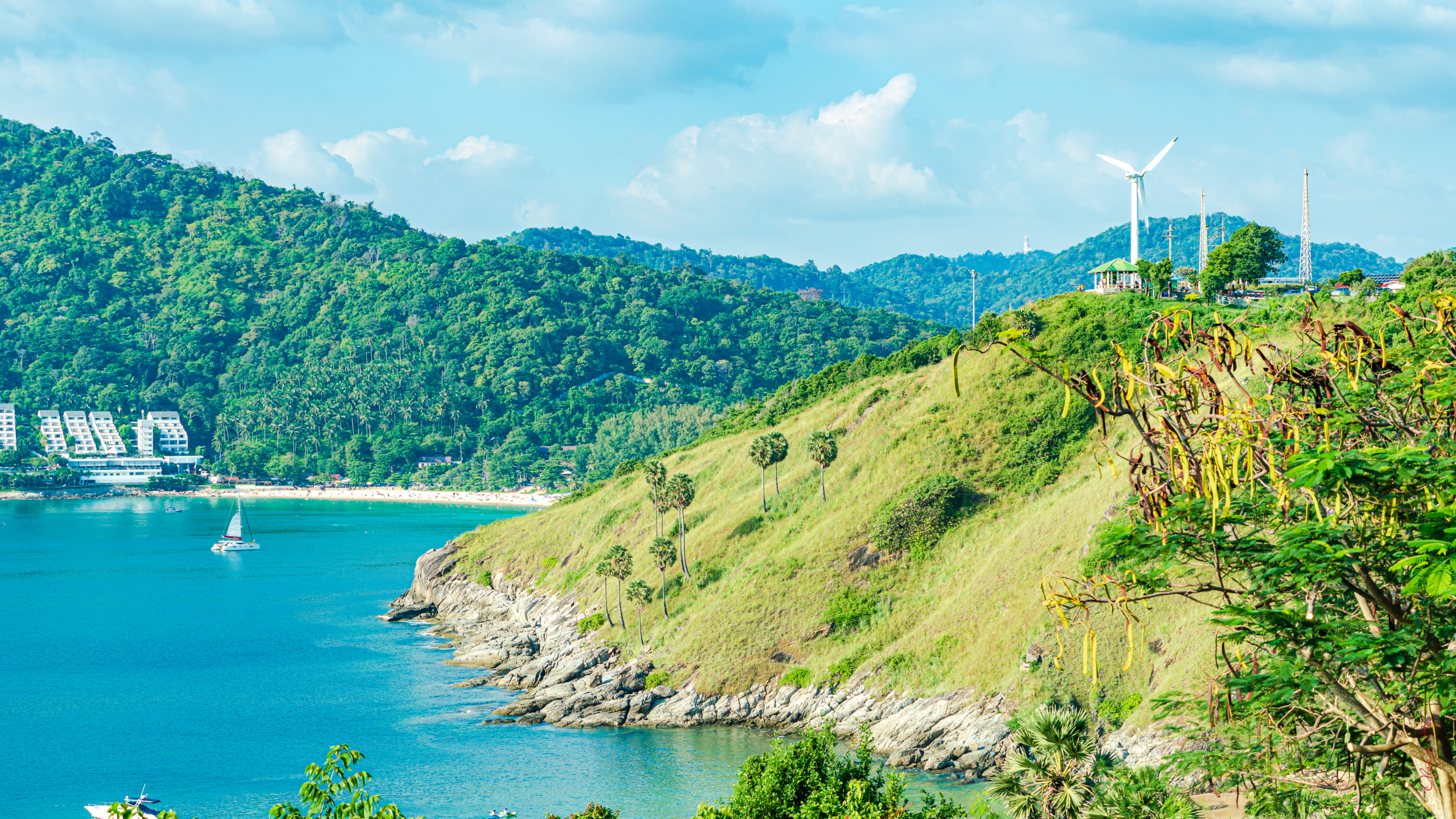 Scenic view of Phuket’s Windmill Viewpoint overlooking Nai Harn Bay with turquoise waters and lush green hills