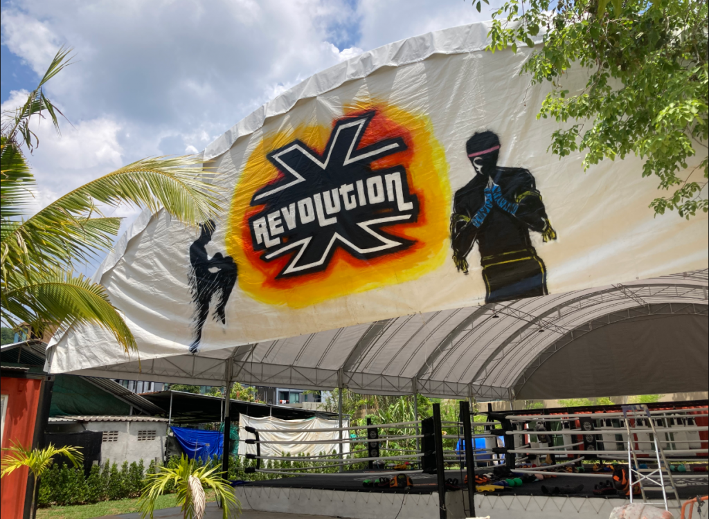 Outdoor Muay Thai boxing ring at Revolution Muay Thai gym in Phuket with branded canopy